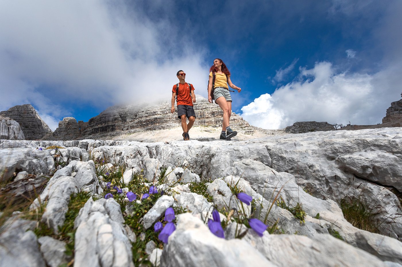 Hiking in the Soča Valley Hikers enjoy the mountains in a bed of flowers