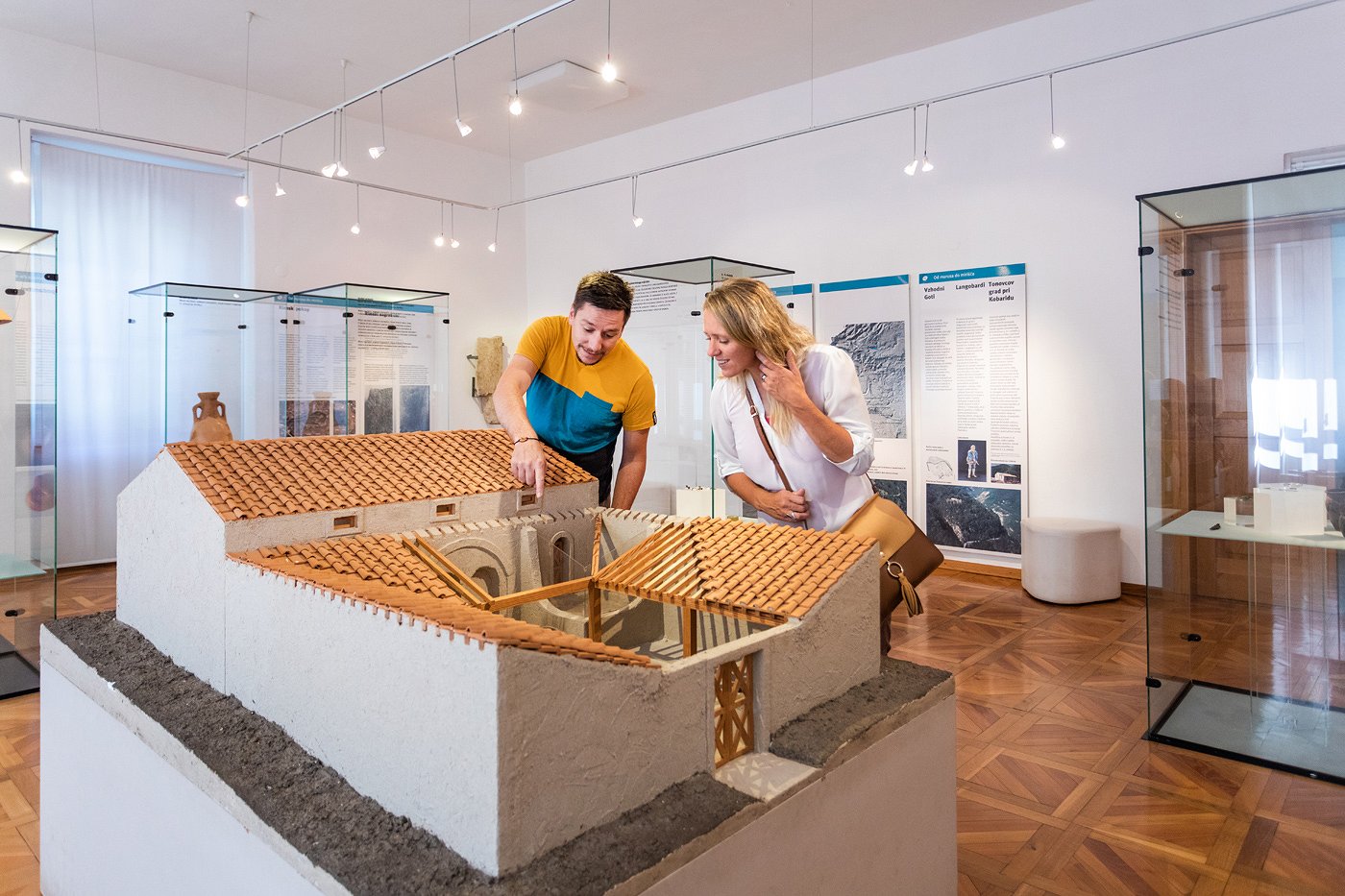 Visitors admire a model of the Roman house